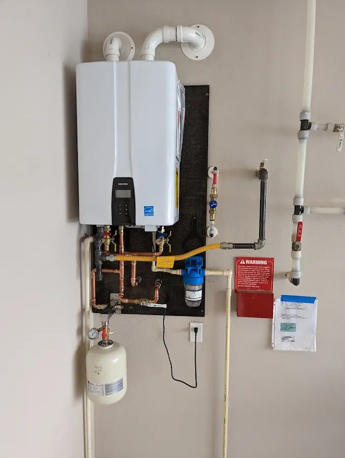 Professional plumber installing copper piping in a Woodstown home